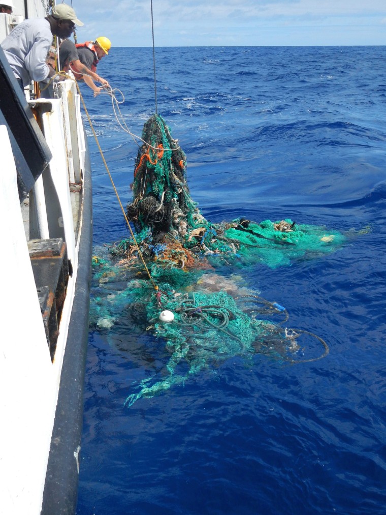 Image: Mega Expedition mothership R/V Ocean Starr crew pull a ghost net from the Pacific Ocean