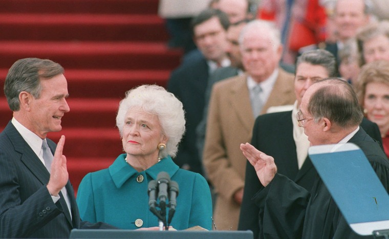 Image:  First lady Barbara Bush holds the bible for her husband George Bush as he is sworn into office