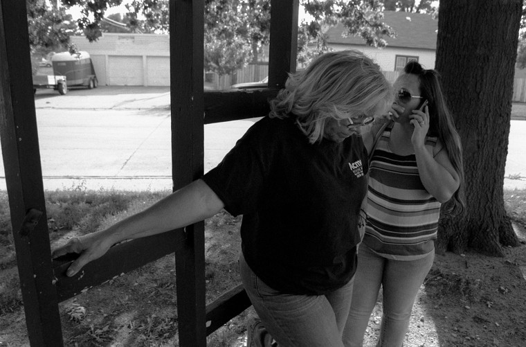 Image: Antonia Correa, leftm waits while Athena Ramos makes a phone call in Grand Island, Nebraska