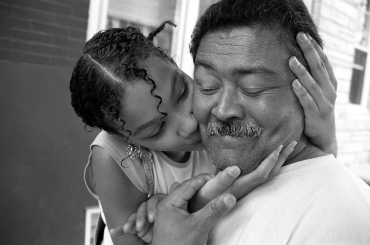 Karina kisses her abuelo after coming home from school