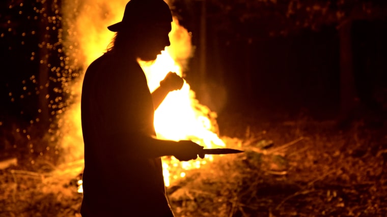 White Nationalist Zach "Rhino" Taylor at a bonfire with his friends at his home near Petit Jean Mountain, Arkansas.