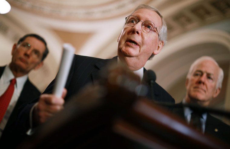 Image: Senate Majority Leader Mitch McConnell talks to reporters