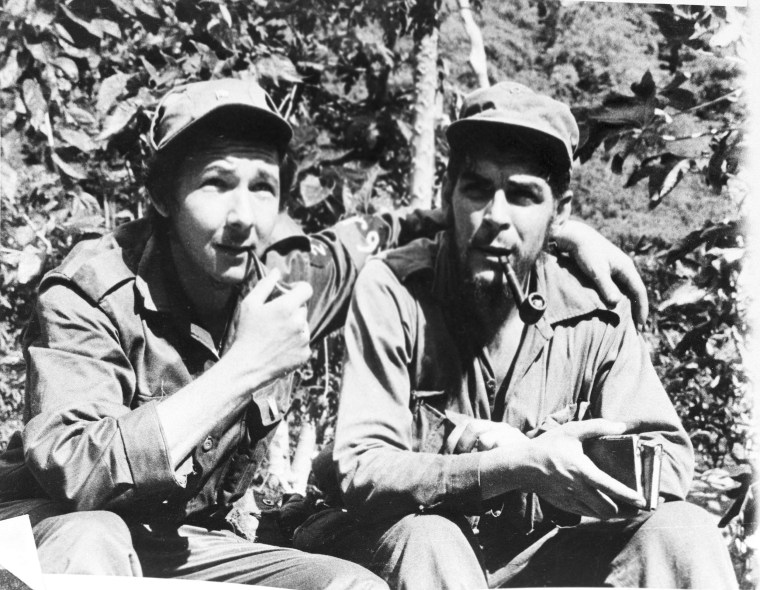 Raul Castro smokes a pipe with Chief Lieutenant Ernesto 'Che' Guevara in their Sierra Cristal mountain stronghold in eastern Cuba, April 1958.