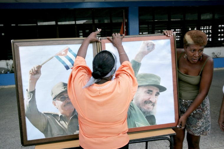 Communist Party members set up framed photographs of the Castros as they prepare for a political rally supporting Fidel Castro and the Revolution on Aug. 4, 2006 in Havana. Four days prior, Fidel temporarily handed power to his brother Raul while he recovered from intestinal surgery.