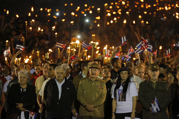 Cuba's President Raul Castro along with Uruguay's former President Jose Mujica, his wife Sen. Lucia Topolansky, President of University Students Federation Jennifer Bello and Revolutionionary Commander Ramiro Valdes,take part in a march with torches to mark the 163rd anniversary of the birth of Cuba's national independence hero Jose Marti, in Havana, Jan. 27, 2016.