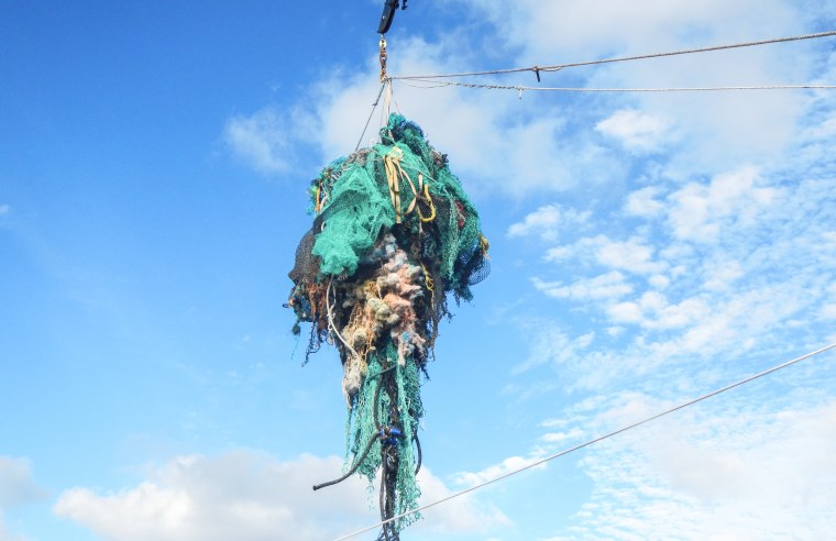 Image: Mega Expedition mothership R/V Ocean Starr crew pull a ghost net from the Pacific Ocean