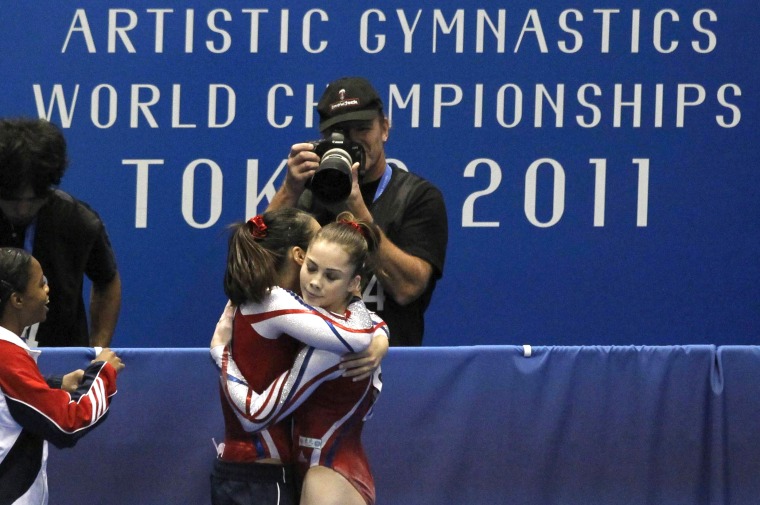 McKayla Maroney of the U.S. hugs a teammate after her competition on the floor during the women's team final at the Artistic Gymnastics World Championships in