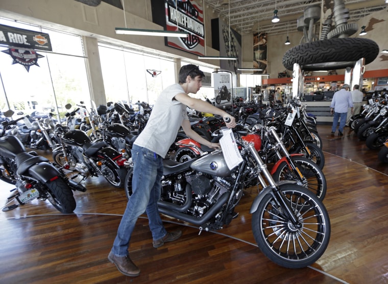 Image: A customer looks at a 2017 Harley-Davidson