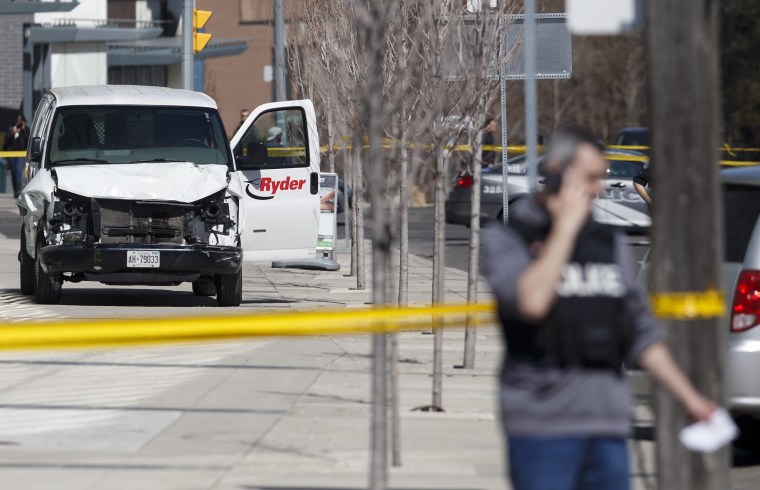 Image: Police inspect a van suspected of being involved in a collision injuring at least eight people