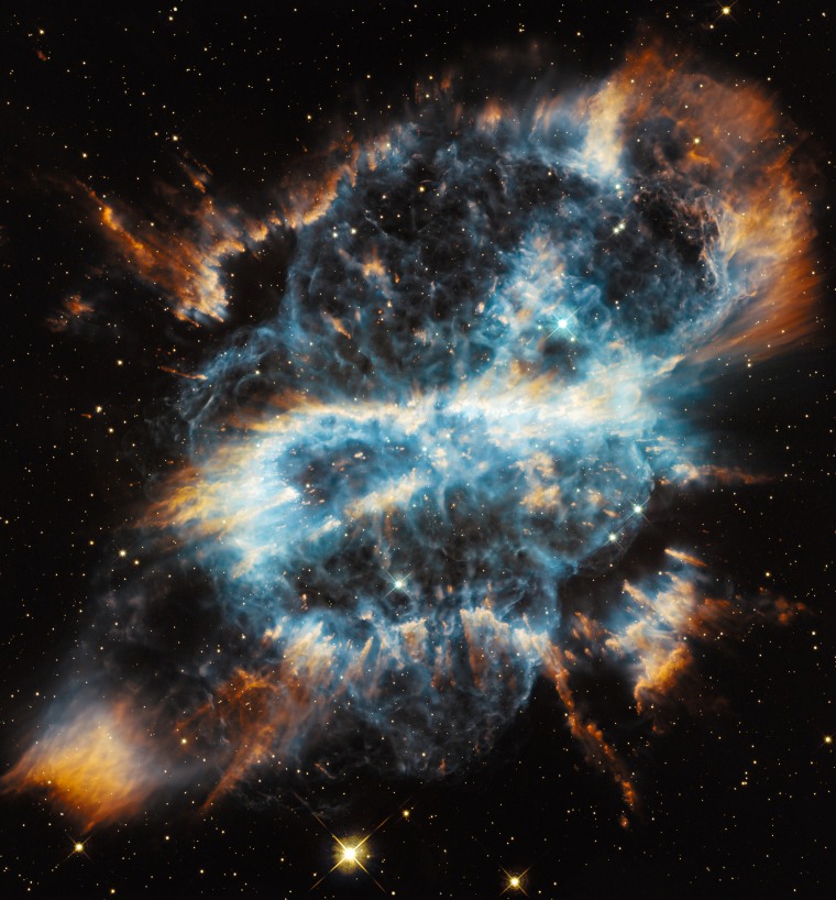 Hubble's website compares this bright gaseous nebula to a festive \"glass-blown holiday ornament with a glowing ribbon,\" but it more closely resembles a menacing skull to some people.  
Planetary nebulae represent the final brief stage in the life of a medium-sized star like our Sun. While consuming the last of the fuel in its core, the dying star expels a large portion of its outer envelope. This material then becomes heated by the radiation from the stellar remnant and radiates, producing glowing clouds of gas that can show complex structures, as the ejection of mass from the star is uneven in both time and direction.