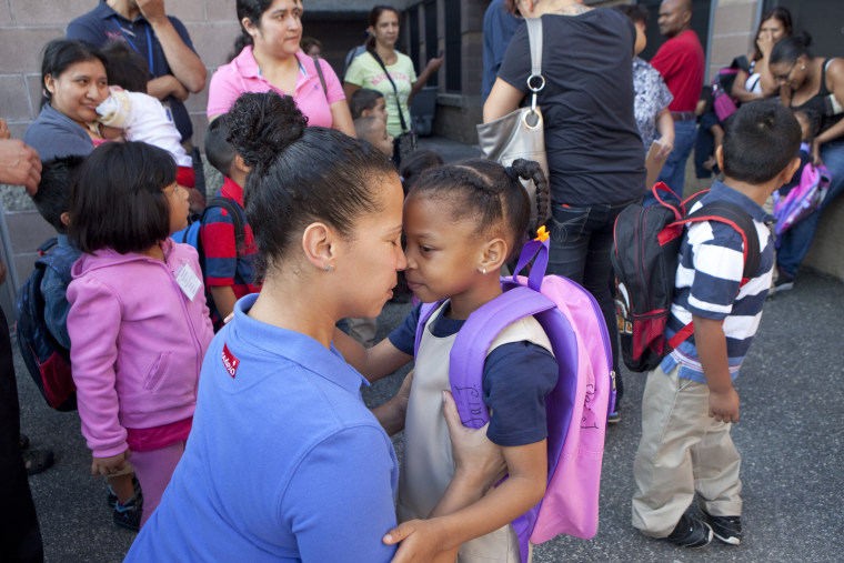 Image: A mom drops off her daughter on her first day of kindergarten