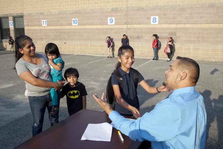 Image: A principal greets students at Leviton Dual Language Elementary School