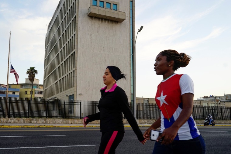 Image: People walk past the U.S. Embassy in Havana