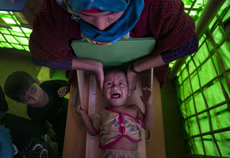 Image: A Rohingya refugee is measured at a malnutrition center