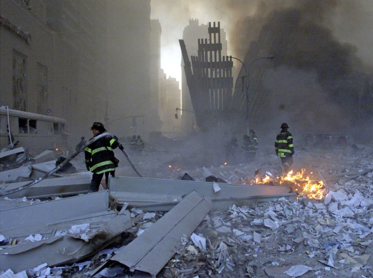Image: File picture shows firemen working around the World Trade Center after both towers collapsed in New York