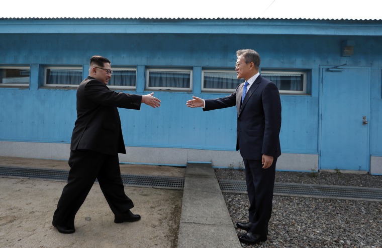 Image: Kim Jong Un and Moon Jae-in shake hands over the military demarcation line.