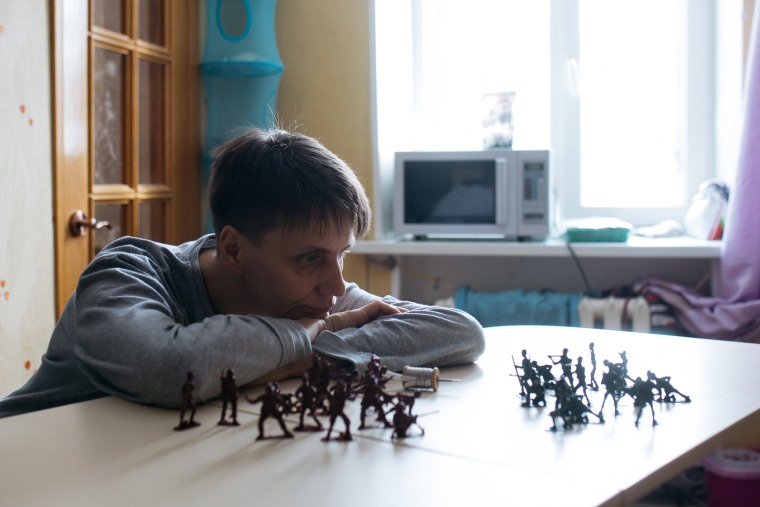 Image: Sasha Phoenix, 48, staring at an army of toy soldiers she used to play with as a child.