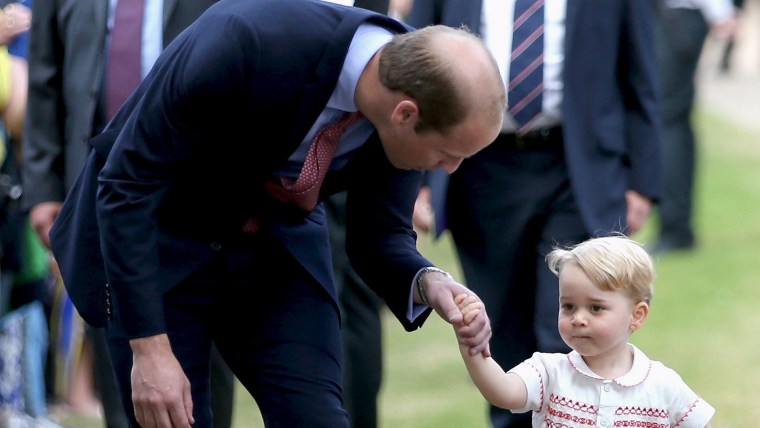 Image: Prince William, Duke of Cambridge speaks with Prince George of Cambridge as they arrive at the Church of St Mary Magdalene on the Sandringham Estate for the Christening of Princess Charlotte of Cambridge