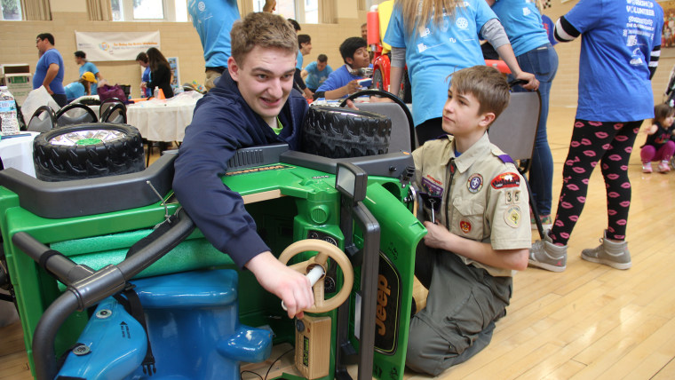 Local businesses and scout groups volunteer to re-fit Power Wheels cars to help children with disabilities have a toy of their own that also helps them be independent.