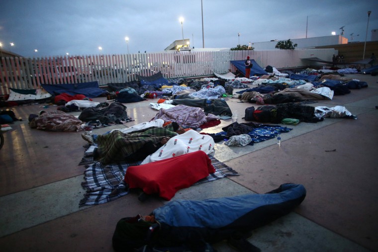 Image: Members of a caravan of migrants from Central America sleep near the San Ysidro checkpoint in Tijuana