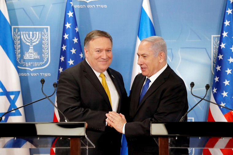 Image: Israeli Prime Minister Benjamin Netanyahu shakes hands with U.S. Secretary of State Mike Pompeo during a meeting at the Ministry of Defence in Tel Aviv