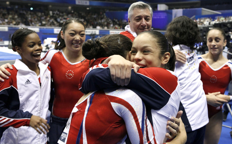 Image: USA's Sabrina Vega, center, celebrates with teammates after winning the women's team final at the Artistic Gymnastics World Championships