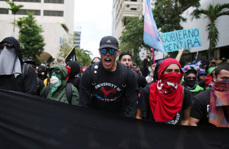Image: Demonstrators march during a May Day protest against austerity measures, in San Juan
