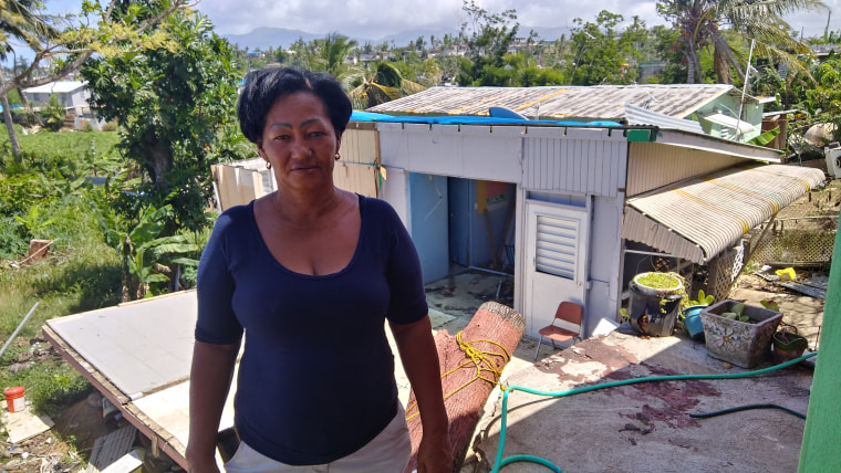 Miriam Medina poses in fron of her house in Barrio Palmarejo in Canovanas, Puerto Rico.