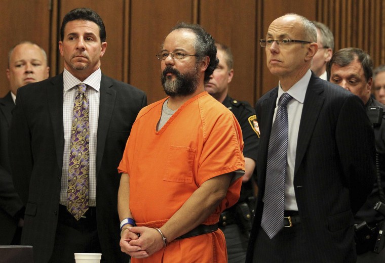 Image: Ariel Castro, 53, stands between attorneys Craig Weintraub and Jaye Schlachet as his sentence is read to him by judge Michael J. Russo in the courtroom in Cleveland