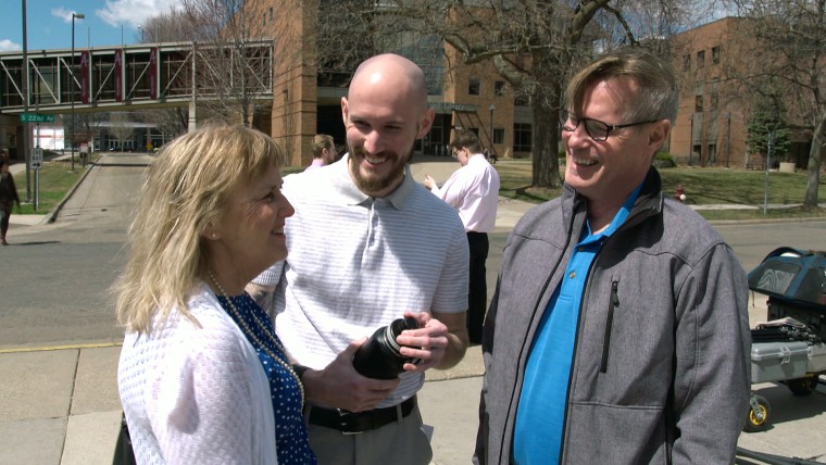 Image: Neil King speaks to his parents after his graduation at Augsburg University.