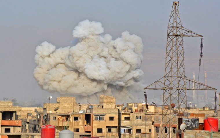 Image: Smoke rises from buildings during regime strikes in Damascus