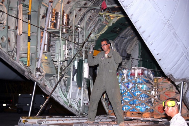 Master Sgt. Eric Circuns waves in a forklift while standing in the rear of a C-130 Hercules, during the evening hours of Oct. 1, 2017. The Puerto Rico Air National Guard is working wih multiple agencies as part of the relief effort for Hurricane Maria, which hit Puerto Rico on Sept. 20.