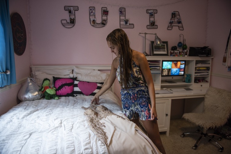 Image: Julia Cordover looks at her dress at her home