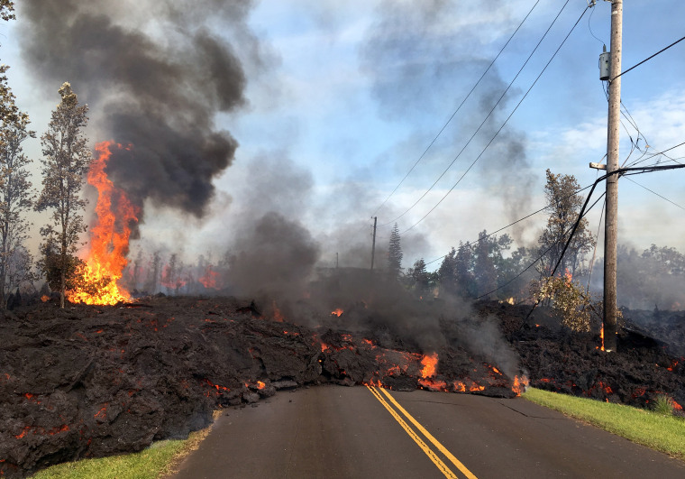 Image: Lava from a fissure slowly advances to the northeast on Hookapu Street after the eruption of Hawaii's Kilauea volcano