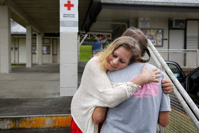 Image: Carolyn McNamara hugs her neighbor Paul Campbell at an evacuation center in Pahoa after moving out of their homes after the Kilauea Volcano erupted, in the Puna community in Hawaii