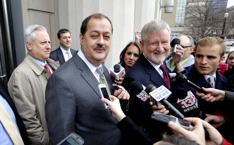 Image: Former Massey Energy Chief Executive Don Blankenship and his attorney Bill Taylor are met by media outside the Robert C. Byrd U.S. Courthouse in Charleston West Virginia