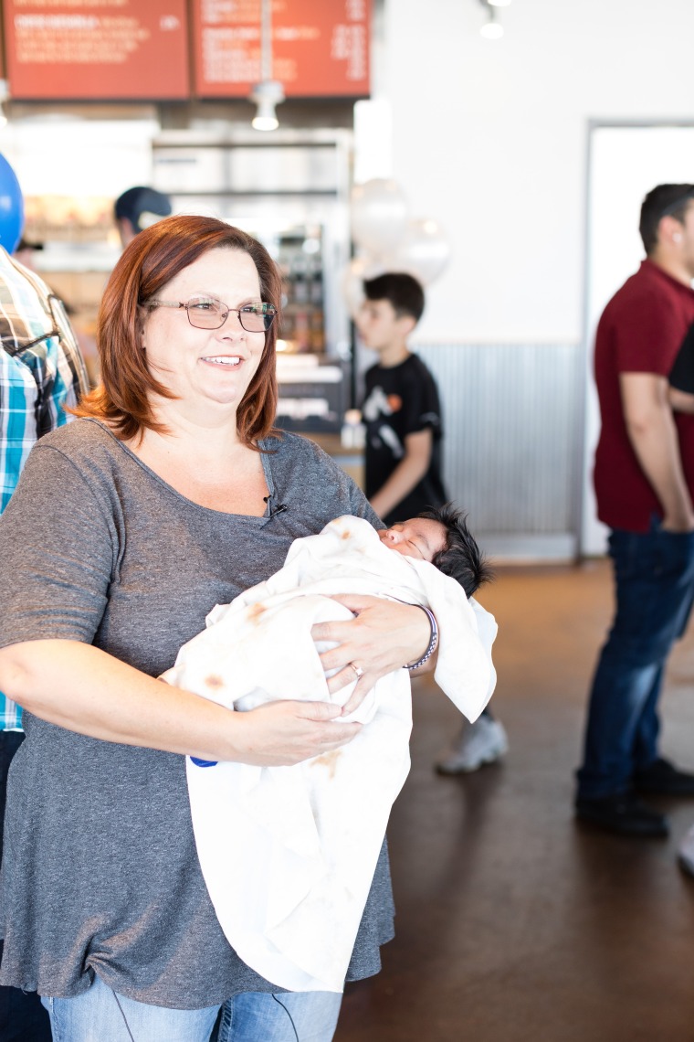 Baby Jaden, who was born in a Chipotle parking lot, wrapped in a burrito baby blanket.