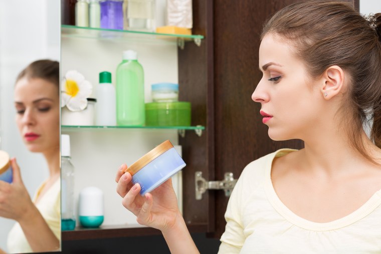 Woman looking at beauty products.