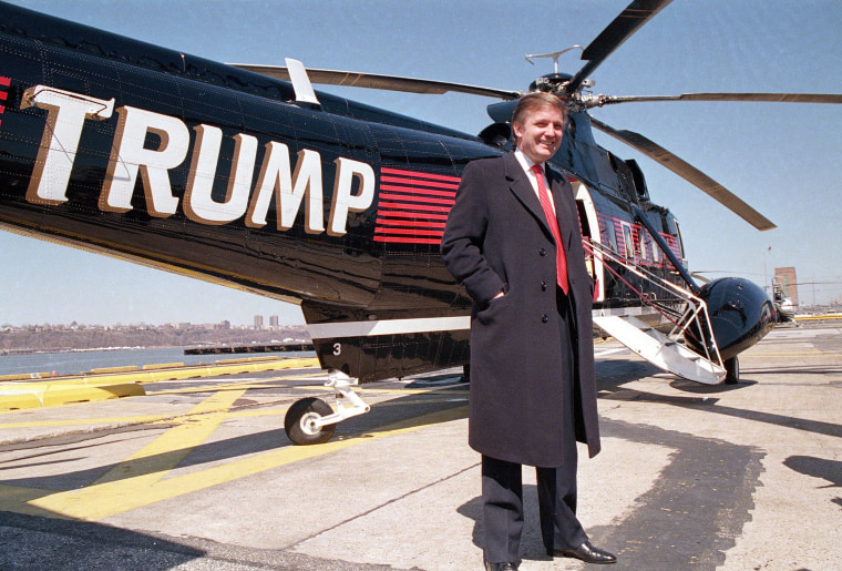 Image: Real estate magnate Donald Trump poses in front of one of three Sikorsky helicopters