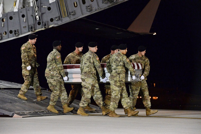 Image: A U.S. Army carry team transfers the remains of Army Staff Sgt. Dustin Wright at Dover Air Force Base in Delaware