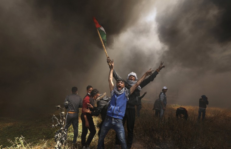 Image: Palestinian demonstrators shout during clashes with Israeli troops at a protest at the Israel-Gaza border east of Gaza City