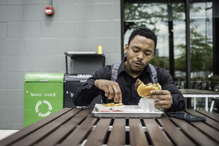 Image: Shadrack Mawolo grabs a burger at a Shake Shack