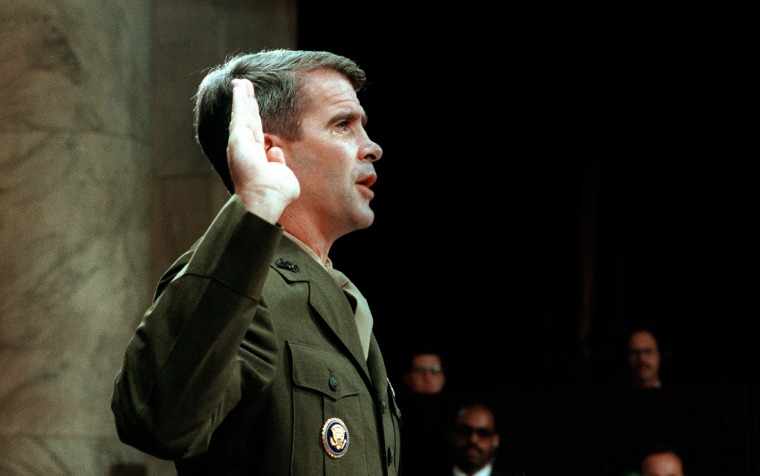 Image: Oliver North is sworn before the House and Senate Foreign Affairs Committee hearing on arms sales to Iran