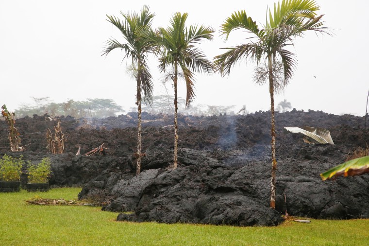 Image: Lava cools in a resident's yard in the Leilani Estates subdivision during ongoing eruptions of the Kilauea Volcano