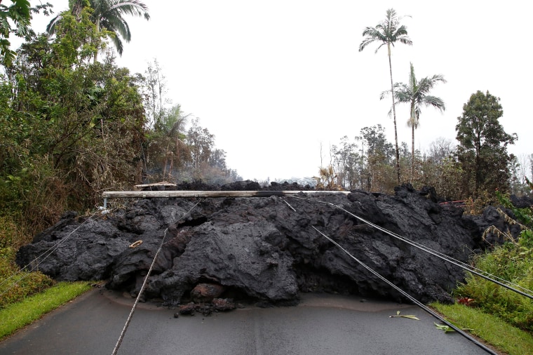 Image: Lava and downed power lines block a road in the Leilani Estates subdivision during ongoing eruptions of the Kilauea Volcano