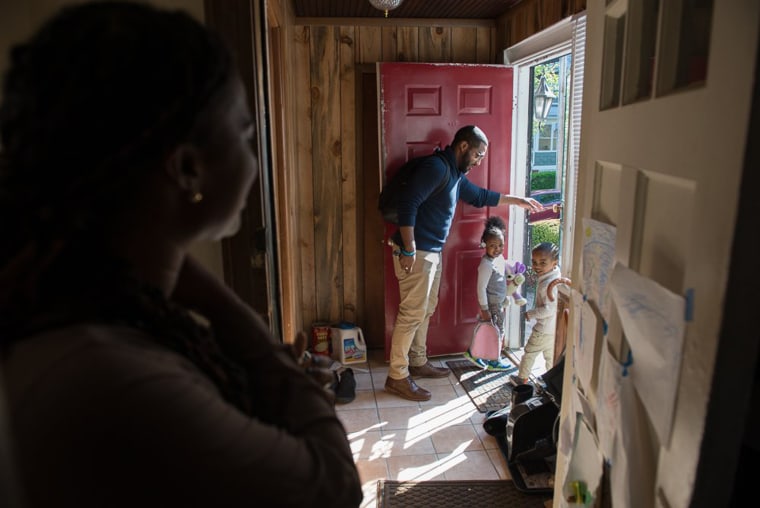 Image: Alia McCants looks on as her husband and children leave their home in White Plains, New York.