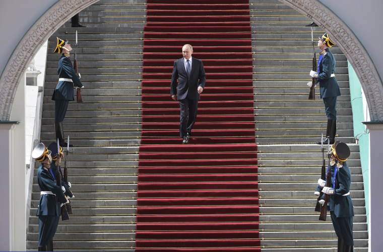 Image: Vladimir Putin leaves following his inauguration ceremony for his fourth term as Russia's president