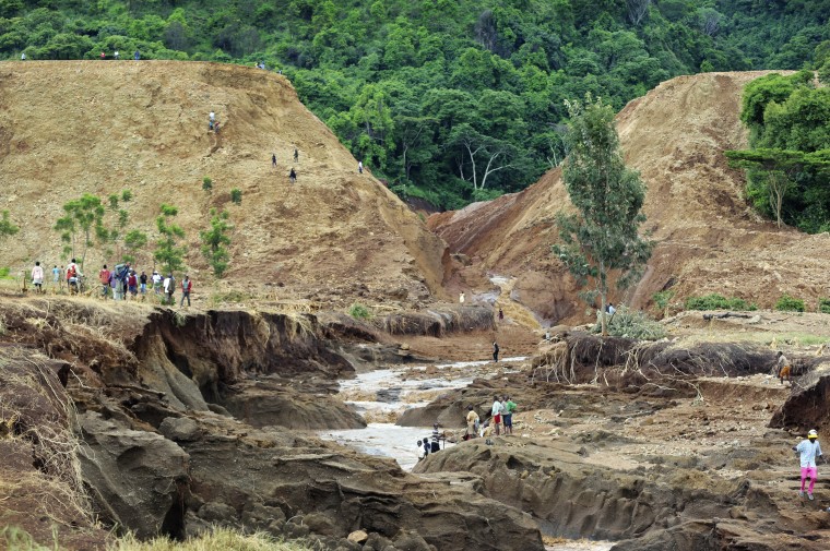 Image: People gather in front of the broken banks of the Patel dam near Solai, Kenya
