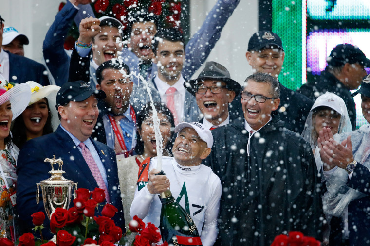 Image: Jockey Mike Smith celebrates after winning the 144th running of the Kentucky Derby