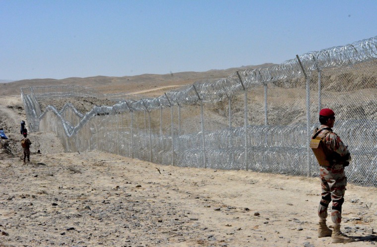 Image: A Pakistani army soldier stands guard along with border fence at the Pakistan-Afghanistan border near the Punjpai area of Quetta in Balochistan on May 8, 2018.